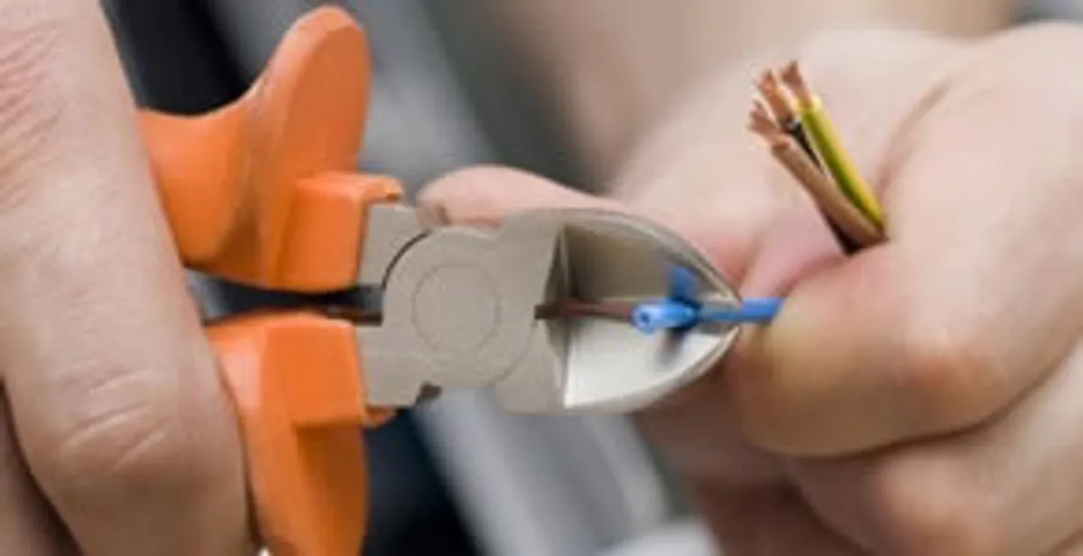 professional electrical services showing precise wire cutting by licensed electricians in Lakeland, FL